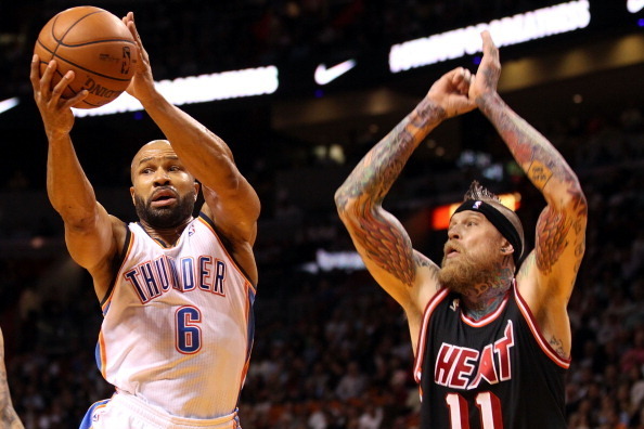 MIAMI, FL - JANUARY 29: Guard Derek Fisher #6 of the Oklahoma City Thunder passes the ball against Forward Chris Anderson #11 of the Miami Heat at AmericanAirlines Arena on January 29, 2014 in Miami, Florida. NOTE TO USER: User expressly acknowledges and 