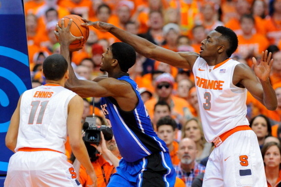 SYRACUSE, NY - FEBRUARY 01:  Amile Jefferson #21 of the Duke Blue Devils drives to the basket against Tyler Ennis #11 and Jerami Grant #3 of the Syracuse Orange during the first half at the Carrier Dome on February 1, 2014 in Syracuse, New York.  Syracuse