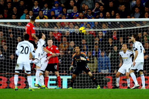 CARDIFF, WALES - NOVEMBER 03:  Steven Caulker of Cardiff City rises highest to score their first goal with a header during the Barclays Premier League match between Cardiff City and Swansea City at Cardiff City Stadium on November 3, 2013 in Cardiff, Wale