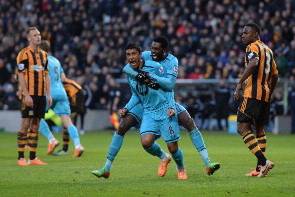 HULL, ENGLAND - FEBRUARY 01:  Paulinho (C) of Tottenham Hotspur celebrates scoring a goal with his team-mate Emmanuel Adebayor during the Barclays Premier League match between Hull City and Tottenham Hotspur at KC Stadium on February 1, 2014 in Hull, Engl