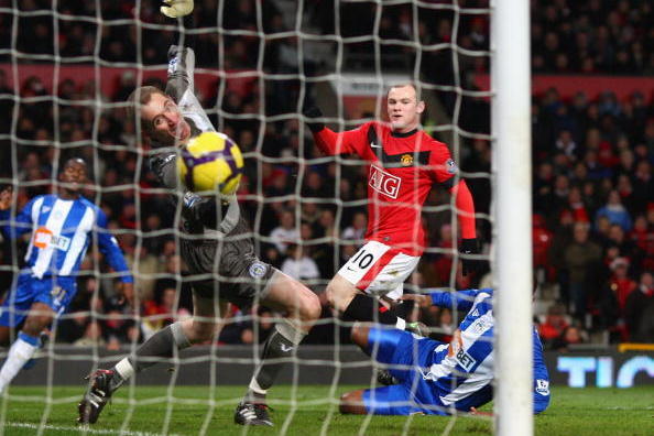 MANCHESTER, ENGLAND - DECEMBER 30:  Wayne Rooney of Manchester United scores the opening goal past Chris Kirkland of Wigan Athletic during the Barclays Premier League match between Manchester United and Wigan Athletic at Old Trafford on December 30, 2009 