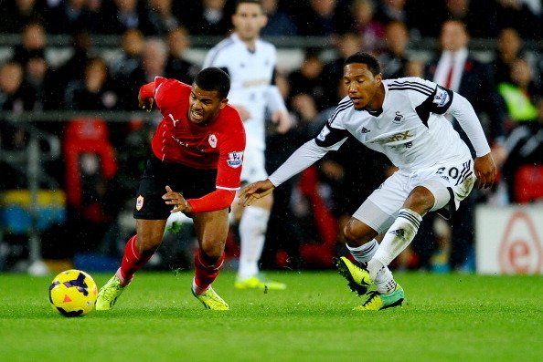 CARDIFF, WALES - NOVEMBER 03:  Fraizer Campbell of Cardiff City evades Jonathan de Guzman of Swansea City during the Barclays Premier League match between Cardiff City and Swansea City at Cardiff City Stadium on November 3, 2013 in Cardiff, Wales.  (Photo