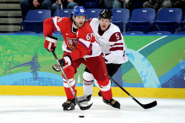 VANCOUVER, BC - FEBRUARY 23:  Jaromir Jagr #68 of Czech Republic is pursued by Janis Sprukts #5 of Latvia during the ice hockey Men's Play-off qualification match between the Czech Republic and Latvia on day 12 of the Vancouver 2010 Winter Olympics at UBC