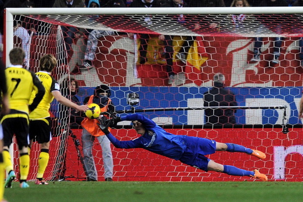 MADRID, SPAIN - JANUARY 19:   Thibaut Courtois of Club Atletico de Madrid fails to save a penalty kick from Ivan Rakitic of Sevilla FC during the La Liga match between Club Atletico de Madrid and Sevilla FC at Vicente Calderon Stadium on January 19, 2014 