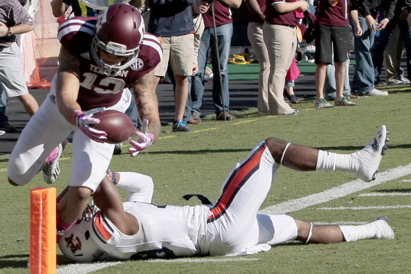 HOUSTON, TX - OCTOBER 19: Mike Evans #13 of the Texas A&M Aggies dives over Ryan White #19 of the Auburn Tigers for a touchdown reception on October 19, 2013 at Kyle Field in College Station, Texas. (Photo by Thomas B. Shea/Getty Images)