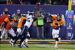 Feb 2, 2014; East Rutherford, NJ, USA;  Denver Broncos quarterback Peyton Manning (18) throws a pass during the second half against the Seattle Seahawks in Super Bowl XLVIII at MetLife Stadium.  Mandatory Credit: Adam Hunger-USA TODAY Sports