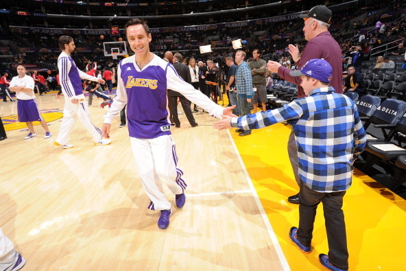LOS ANGELES, CA - NOVEMBER 3: Steve Nash #10 of the Los Angeles Lakers high-fives a fan before a game against the Atlanta Hawks on November 3, 2013 at STAPLES Center in Los Angeles, California. NOTE TO USER: User expressly acknowledges and agrees that, by