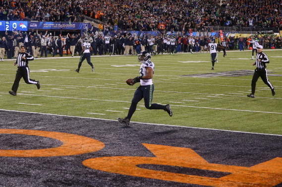 EAST RUTHERFORD, NJ - FEBRUARY 02:  Outside linebacker Malcolm Smith #53 of the Seattle Seahawks runs 69-yards for a touchdown after intercepting a pass intended for running back Knowshon Moreno #27 of the Denver Broncos in the second quarter during Super