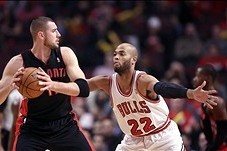 Dec 31, 2013; Chicago, IL, USA; Toronto Raptors center Jonas Valanciunas (17) is defended by Chicago Bulls power forward Taj Gibson (22) during the first quarter at the United Center. Mandatory Credit: Dennis Wierzbicki-USA TODAY Sports