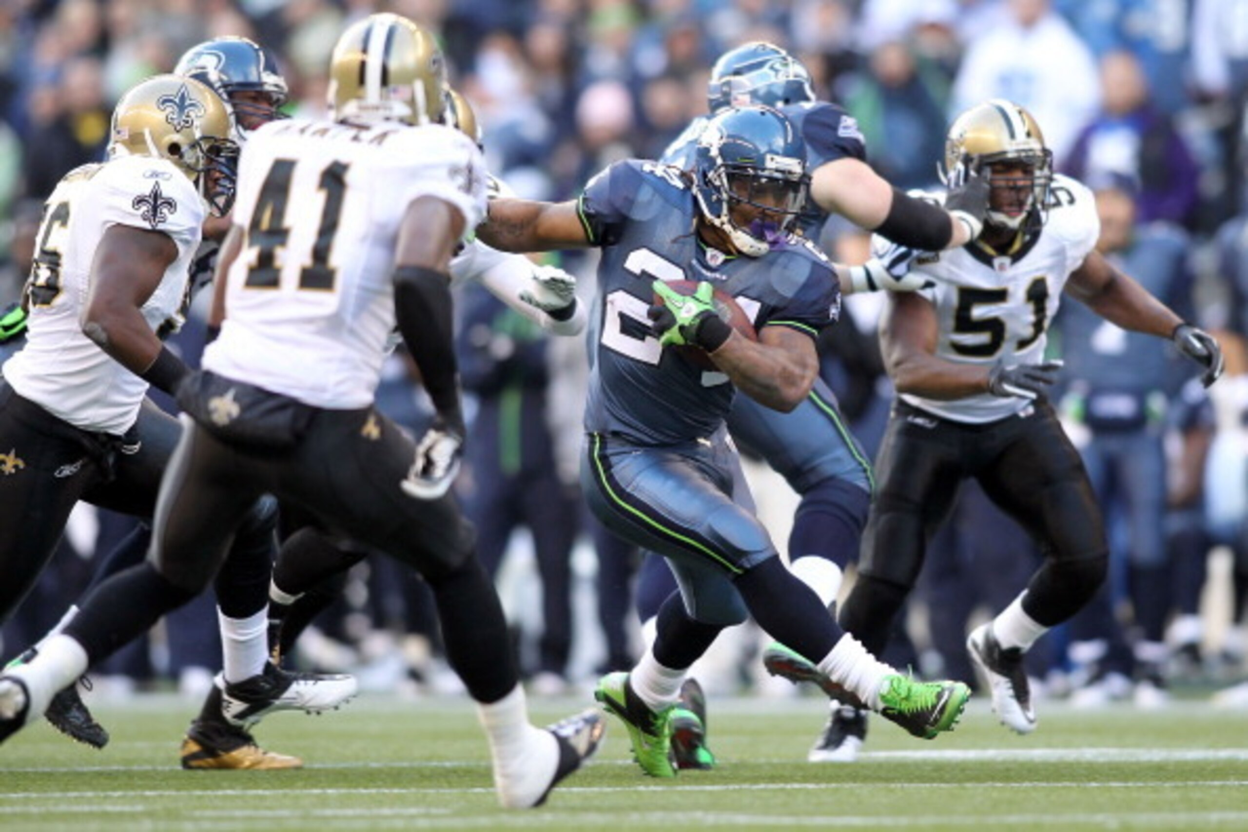 SEATTLE, WA - JANUARY 08:  Marshawn Lynch #24 of the Seattle Seahawks runs the ball in the first half against the New Orleans Saints during the 2011 NFC wild-card playoff game at Qwest Field on January 8, 2011 in Seattle, Washington.  (Photo by Jonathan F