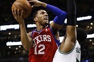 Jan 29, 2014; Boston, MA, USA; Philadelphia 76ers small forward Evan Turner (12) shoots the ball against Boston Celtics center Jared Sullinger (right) during the first half at TD Garden. Mandatory Credit: Mark L. Baer-USA TODAY Sports