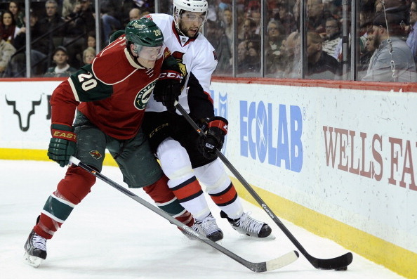 ST. PAUL, MN - JANUARY 14:  Jared Cowen #2 of the Ottawa Senators controls the puck against Ryan Suter #20 of the Minnesota Wild during the second period of the game on January 14, 2014 at Xcel Energy Center in St. Paul, Minnesota. (Photo by Hannah Foslie