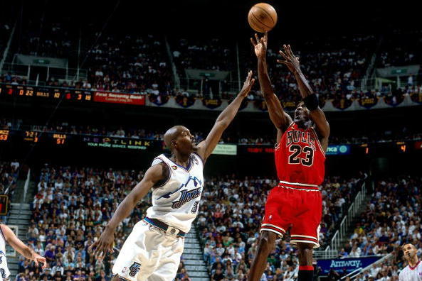 SALT LAKE CITY - JUNE 14:  Michael Jordan #23 of the Chicago Bulls shoots a jump shot against Bryon Russell #3 the Utah Jazz in Game Six of the 1998 NBA Finals against the Chicago Bulls at the Delta Center on June 14, 1998 in Salt Lake City, Utah.  The Bu