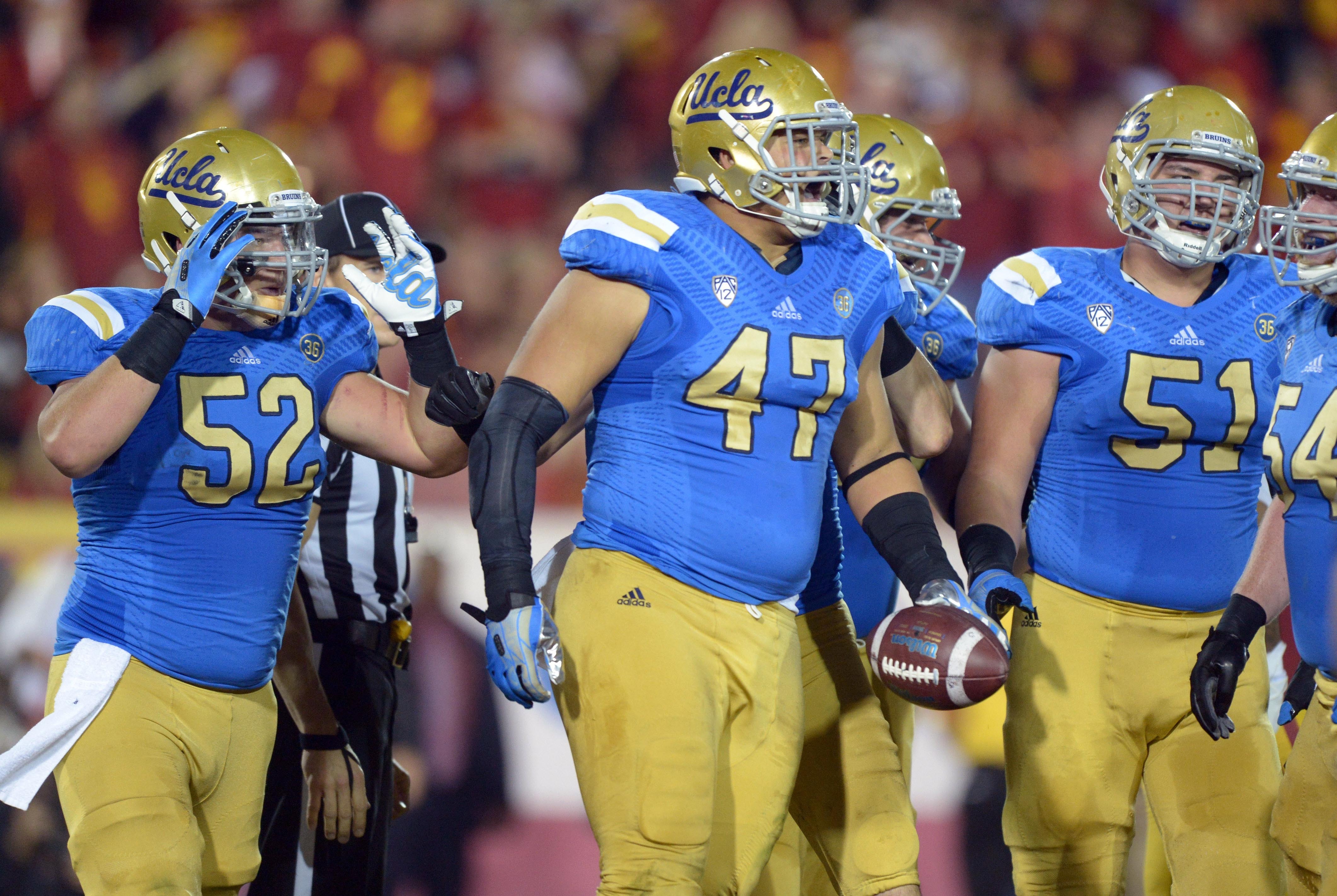 Nov 30, 2013; Los Angeles, CA, USA; UCLA Bruins defensive end Eddie Vanderdoes (47) celebrates after scoring on a 1-yard touchdown run in the second quarter against the Southern California Trojans at Los Angeles Memorial Coliseum. Mandatory Credit: Kirby