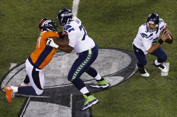EAST RUTHERFORD, NJ - FEBRUARY 02:  quarterback Russell Wilson #3 of the Seattle Seahawks looks to pass against the Denver Broncos during Super Bowl XLVIII at MetLife Stadium on February 2, 2014 in East Rutherford, New Jersey.  (Photo by Jeff Zelevansky/G