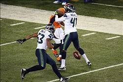 Feb 2, 2014; East Rutherford, NJ, USA; Seattle Seahawks cornerback Byron Maxwell (41) forces the fumble of Denver Broncos wide receiver Demaryius Thomas (88) during the third quarter in Super Bowl XLVIII at MetLife Stadium.  Mandatory Credit: Noah K. Murr