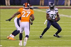 Feb 2, 2014; East Rutherford, NJ, USA; Seattle Seahawks strong safety Kam Chancellor (31) runs with the ball after an interception during the first half against the Denver Broncos in Super Bowl XLVIII at MetLife Stadium.  Mandatory Credit: Adam Hunger-USA