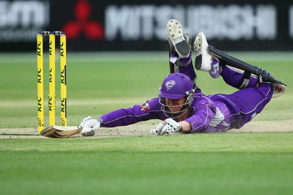 MELBOURNE, AUSTRALIA - JANUARY 21: Ben Dunk of the Hurricanes dives to make his ground during the Big Bash League match between the Melbourne Stars and the Hobart Hurricanes at Melbourne Cricket Ground on January 21, 2014 in Melbourne, Australia.  (Photo 