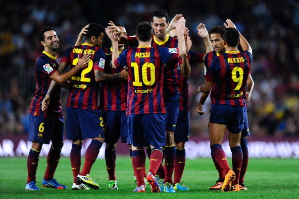 BARCELONA, SPAIN - SEPTEMBER 24:  Sergio Busquets (C) of FC Barcelona celebrates with his team-mates after scoring his team's third goal during the La Liga match between FC Barcelona and Real Sociedad de Futbol at Camp Nou on September 24, 2013 in Barcelo