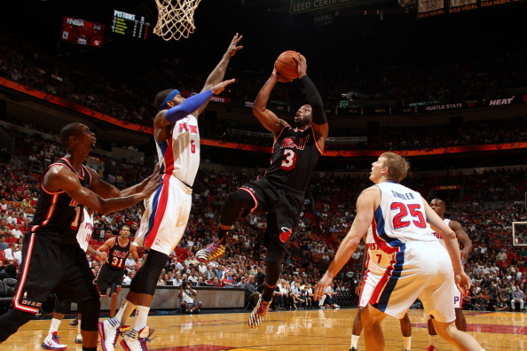 MIAMI, FL - FEBRUARY 3:  Dwyane Wade #3 of the Miami Heat shoots against Josh Smith #6 of the Detroit Pistons at the American Airlines Arena in Miami, Florida on February 3, 2014. NOTE TO USER: User expressly acknowledges and agrees that, by downloading a