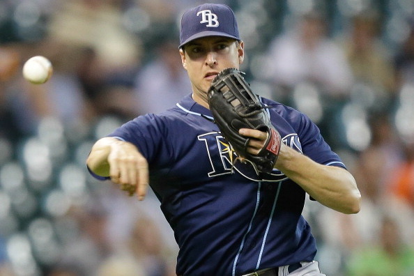 HOUSTON, TX - JULY 03: Kelly Johnson #2 of the Tampa Bay Rays throws to first base to retire Brandon Barnes #2 of the Houston Astros in the second inning at Minute Maid Park on July 3, 2013 in Houston, Texas. (Photo by Bob Levey/Getty Images)