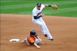 Sep 19, 2013; Cleveland, OH, USA; Cleveland Indians shortstop Asdrubal Cabrera (13) turns a double play over Houston Astros third baseman Matt Dominguez (30) in the fourth inning at Progressive Field. Mandatory Credit: David Richard-USA TODAY Sports