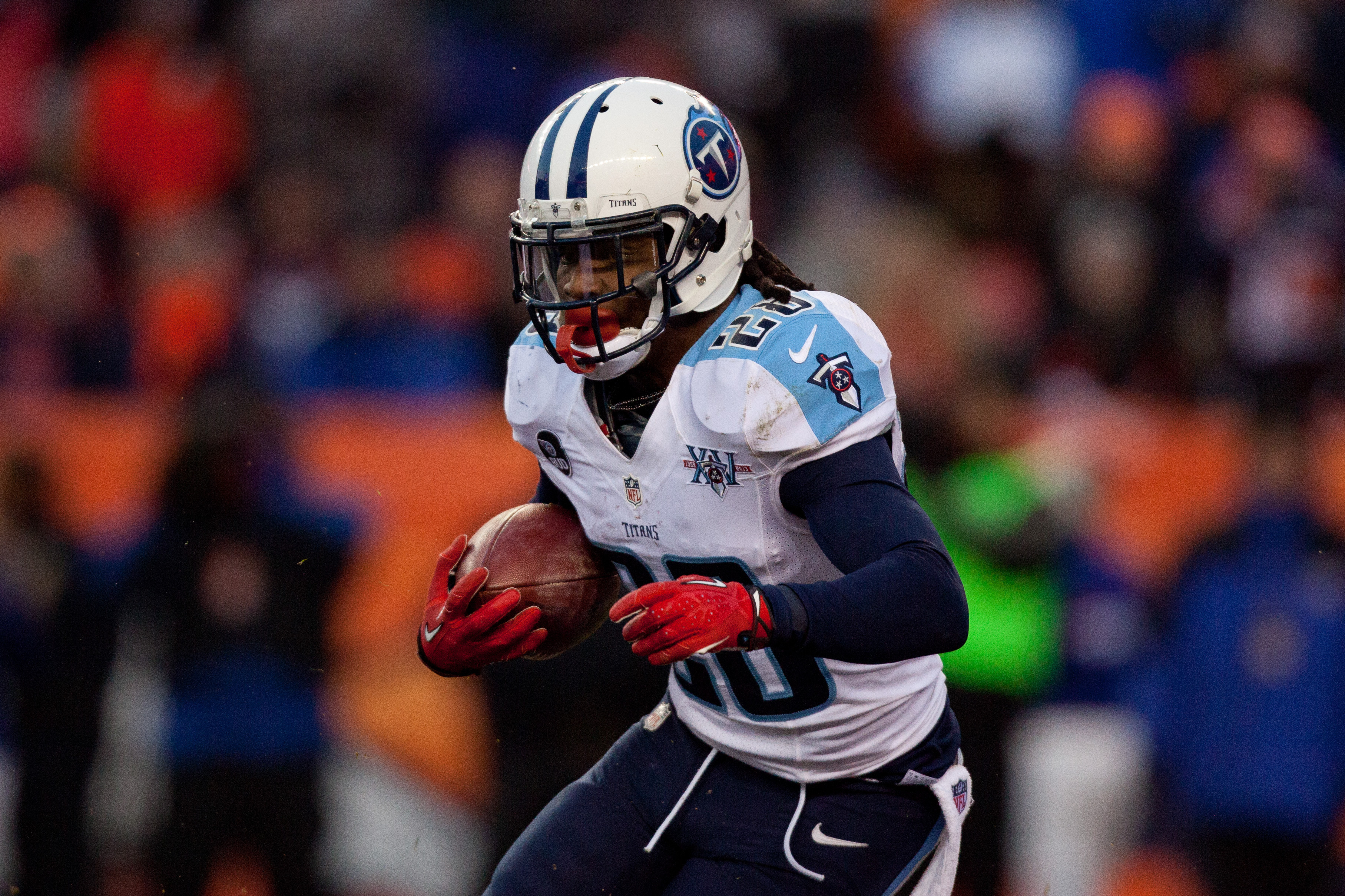 DENVER, CO - DECEMBER 8:  Running back Chris Johnson #28 of the Tennessee Titans runs with the ball against the Denver Broncos at Sports Authority Field Field at Mile High on December 8, 2013 in Denver, Colorado. The Broncos defeated the Titans 51-28.  (P
