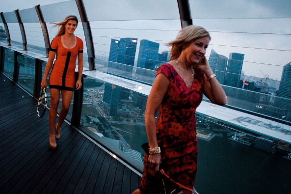 SINGAPORE - JANUARY 27:  Eugenie Bouchard and Chris Evert walk across the platform after a photo shoot session January 27, 2014 in Singapore.  (Photo by Rahman Roslan/Getty Images for WTA)