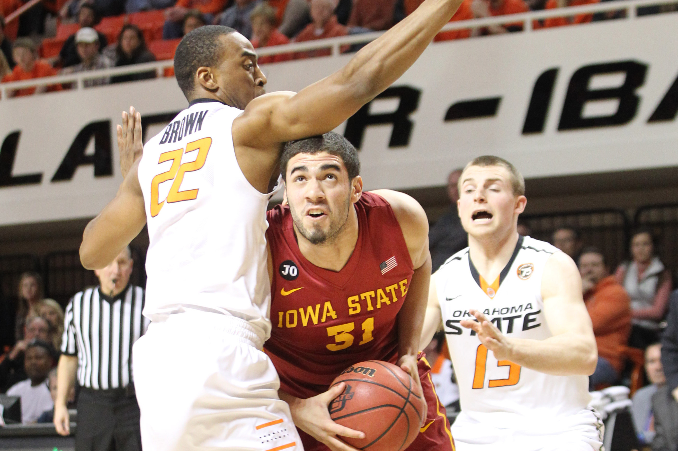Feb 3, 2014; Stillwater, OK, USA; Iowa State Cyclones forward Georges Niang (31) drives between Oklahoma State Cowboys guards Markel Brown (22) and Phil Forte (13) at Gallagher-Iba Arena. Mandatory Credit: Nelson Chenault-USA TODAY Sports