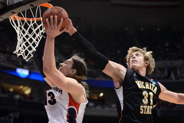 SALT LAKE CITY, UT - MARCH 23:  Kelly Olynyk #13 of the Gonzaga Bulldogs has his shot blocked by Ron Baker #31 of the Wichita State Shockers in the second half during the third round of the 2013 NCAA Men's Basketball Tournament at EnergySolutions Arena on