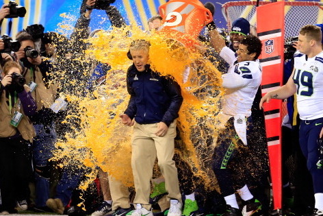 EAST RUTHERFORD, NJ - FEBRUARY 02:  Tight end Zach Miller #86 and quarterback Russell Wilson #3 of the Seattle Seahawks dump Gatorade on head coach Pete Carroll in the fourth quarter of Super Bowl XLVIII against the Denver Broncos at MetLife Stadium on Fe