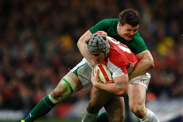 CARDIFF, WALES - MARCH 12:  Jonathan Davies of Wales is wrapped up by Brian O'Driscoll of Ireland during the RBS Six Nations Championship match between Wales and Ireland at the Millennium Stadium on March 12, 2011 in Cardiff, Wales.  (Photo by Laurence Gr