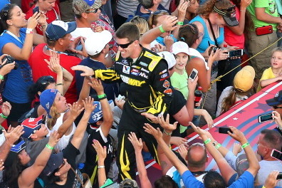 DAYTONA BEACH, FL - JULY 06:  Carl Edwards, driver of the #99 SUBWAY Ford, greets fans during driver introductions during the NASCAR Sprint Cup Series Coke Zero 400 at Daytona International Speedway on July 6, 2013 in Daytona Beach, Florida.  (Photo by Mi