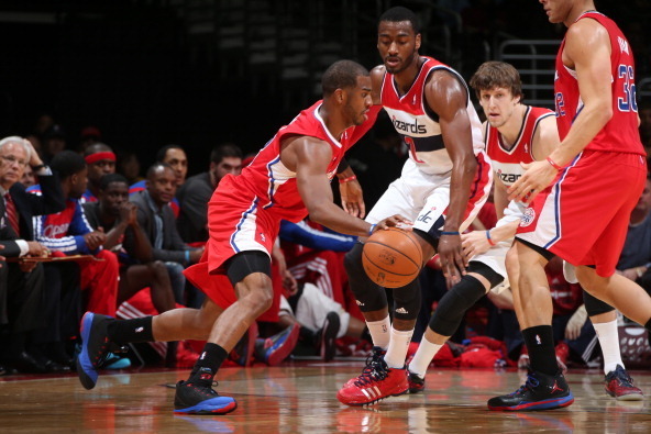 WASHINGTON, DC - DECEMBER 14: Chris Paul #3 of the Los Angeles Clippers drives against John Wall #2 of the Washington Wizards during the game at the Verizon Center on December 14, 2013 in Washington, DC. NOTE TO USER: User expressly acknowledges and agree