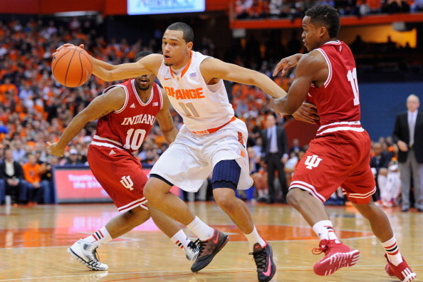 SYRACUSE, NY - DECEMBER 03:  Tyler Ennis #11 of the Syracuse Orange controls a loose ball between the defense of Evan Gordon #10 and Yogi Ferrell #11 of the Indiana Hoosiers during the first half at the Carrier Dome on December 3, 2013 in Syracuse, New Yo