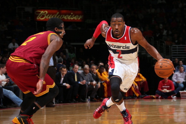 WASHINGTON, DC - NOVEMBER 16: John Wall #2 of the Washington Wizards drives against Kyrie Irving #2 of the Cleveland Cavaliers during the game at the Verizon Center on November 16, 2013 in Washington, DC. NOTE TO USER: User expressly acknowledges and agre