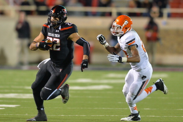 LUBBOCK, TX - NOVEMBER 2: Jace Amaro #22 of the Texas Tech Red Raiders runs away from the Oklahoma State Cowboy defense during game action on November 2, 2013 at AT&T Jones Stadium in Lubbock, Texas. Oklahoma State won the game 52-34. (Photo by John Weast