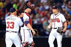 Oct 3, 2013; Atlanta, GA, USA; Atlanta Braves manager Fredi Gonzalez (33) relieves starting pitcher Kris Medlen (54) during the fifth inning of game one of the National League divisional series playoff baseball game against the Los Angeles Dodgers at Turn