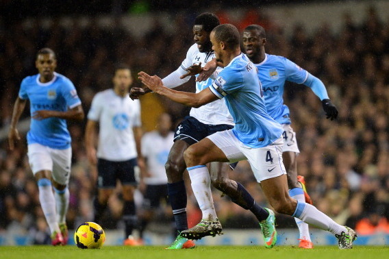 LONDON, ENGLAND - JANUARY 29:  Emmanuel Adebayor of Tottenham Hotspur and Vincent Kompany of Manchester City battle for the ball during the Barclays Premier League match between Tottenham Hotspur and Manchester City at White Hart Lane on January 29, 2014 