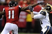Sep 15, 2013; Atlanta, GA, USA; Atlanta Falcons wide receiver Julio Jones (11) straight arms St. Louis Rams cornerback Cortland Finnegan (31) during the second half at Georgia Dome. The Falcons defeated the Rams 31-24. Mandatory Credit: Dale Zanine-USA TO