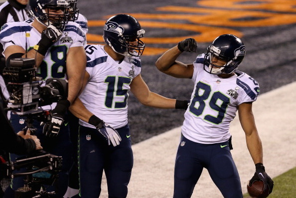 EAST RUTHERFORD, NJ - FEBRUARY 02: Wide receiver Doug Baldwin #89 of the Seattle Seahawks  celebrates his fourth quarter touchdown during Super Bowl XLVIII at MetLife Stadium on February 2, 2014 in East Rutherford, New Jersey.  (Photo by Christian Peterse