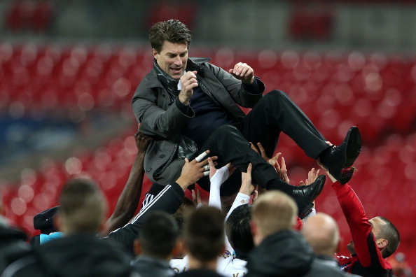 LONDON, ENGLAND - FEBRUARY 24:  Swansea players lift up Manager of Swansea City Michael Laudrup after their 5-0 victory in the Capital One Cup Final match between Bradford City and Swansea City at Wembley Stadium on February 24, 2013 in London, England.  