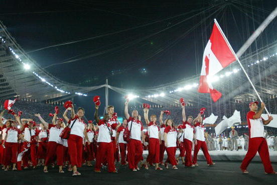 ATHENS - AUGUST 13:  Flag bearer Nicolas Gill leads the delegation from Canada as they walk during the parade of nations, part of the opening ceremonies for the Athens 2004 Summer Olympic Games on August 13, 2004 at the Sports Complex Olympic Stadium in A