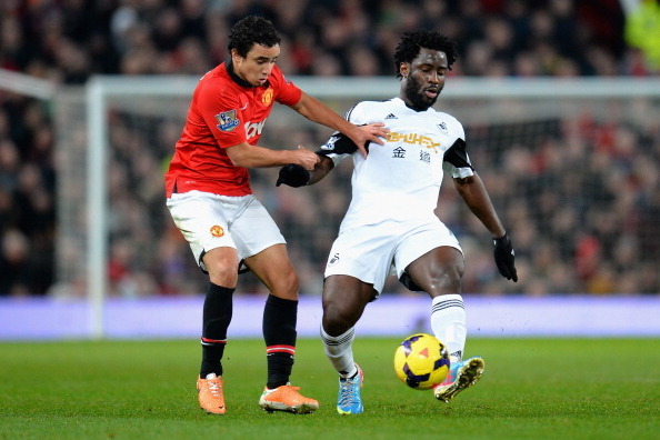 MANCHESTER, ENGLAND - JANUARY 11:  Wilfried Bony of Swansea City competes with Rafael Da Silva of Manchester United during the Barclays Premier League match between Manchester United and Swansea City at Old Trafford on January 11, 2014 in Manchester, Engl
