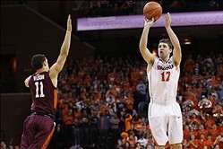 Jan 25, 2014; Charlottesville, VA, USA; Virginia Cavaliers guard Joe Harris (12) shoots the ball over Virginia Tech Hokies guard Devin Wilson (11) in the second half at John Paul Jones Arena. The Cavaliers won 65-45. Mandatory Credit: Geoff Burke-USA TODA