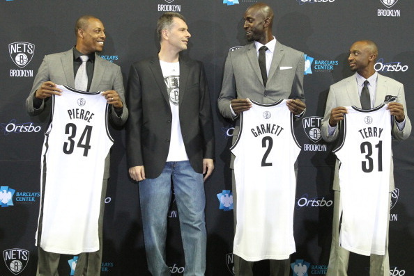 BROOKLYN, NY - July 18: Nets majority owner Mikhail Prokhorov joins Kevin Garnett #2, Paul Pierce #34, and Jason Terry #31 of the Brooklyn Nets during a press conference at the Barclays Center on July 18, 2013 in the Brooklyn borough of New York City.  NO
