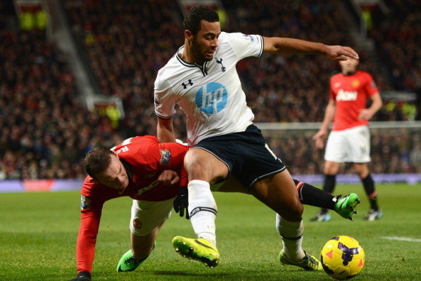 MANCHESTER, ENGLAND - JANUARY 01:  Wayne Rooney of Manchester United tangles with Mousa Dembele of Tottenham Hotspur during the Barclays Premier League match between Manchester United and Tottenham Hotspur at Old Trafford on January 1, 2014 in Manchester,