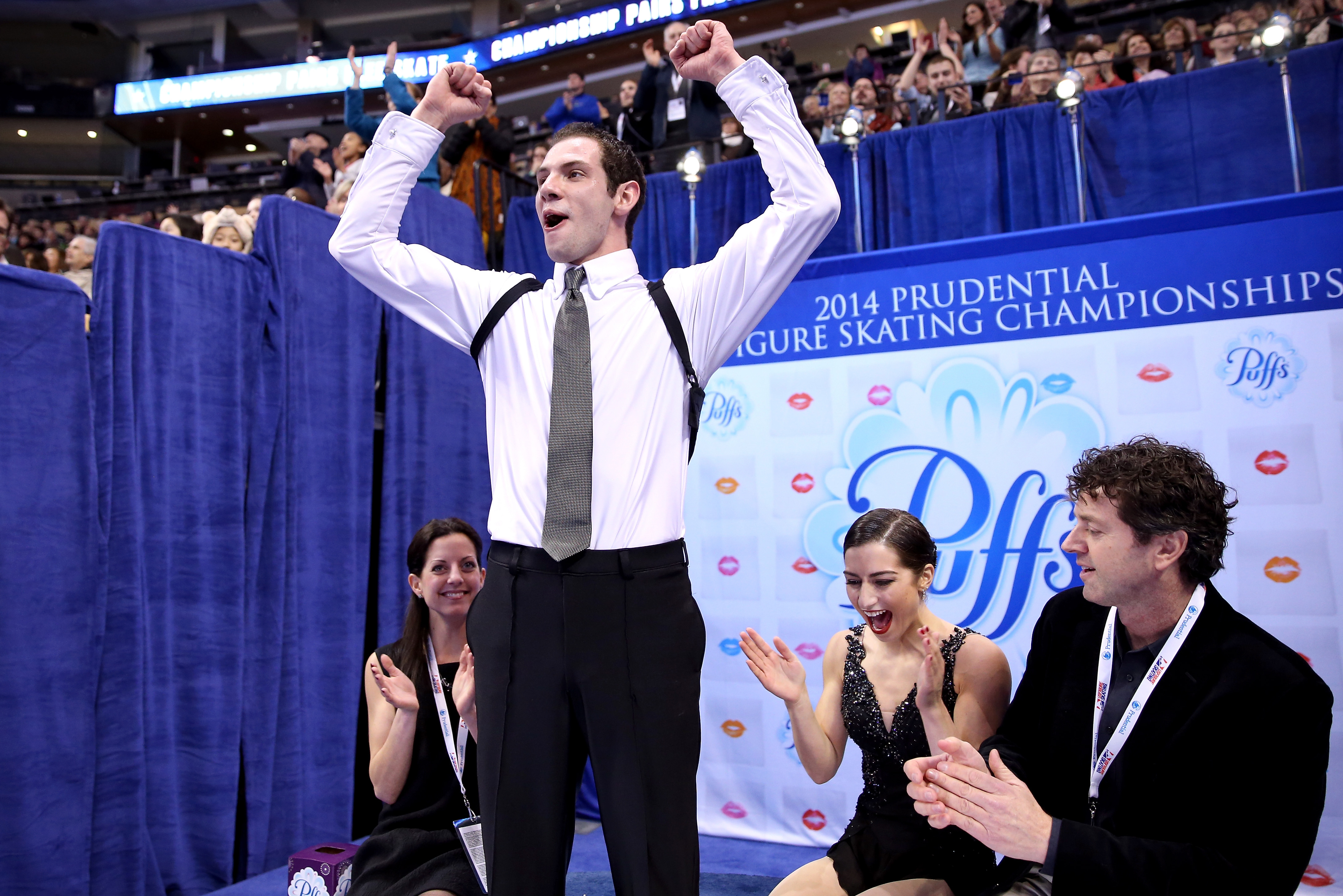 BOSTON, MA - JANUARY 11:  Simon Shnapir and Marissa Castelli, with their coaches Carrie Wall and Bobby Martin, celebrate in the kiss and cry after skating in the pairs free skate during the Prudential U.S. Figure Skating Championships at TD Garden on Janu