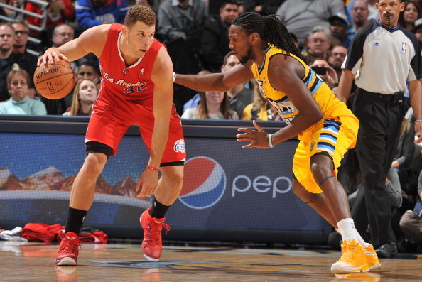 DENVER, CO - FEBRUARY 3: Blake Griffin #32 of the Los Angeles Clippers dribbles the ball against Kenneth Faried #35 of the Denver Nuggets on February 3, 2014 at the Pepsi Center in Denver, Colorado. NOTE TO USER: User expressly acknowledges and agrees tha