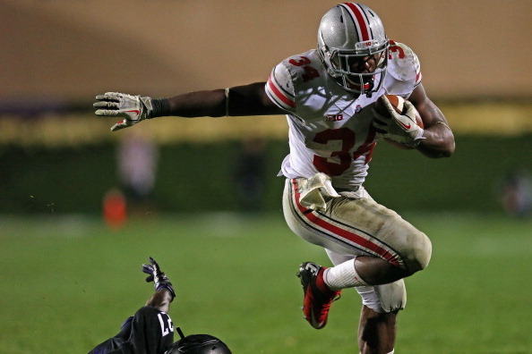 EVANSTON, IL - OCTOBER 05:  Carlos Hyde #34 of the Ohio State Buckeyes runs over Matthew Harris #27 of the Northwestern Wildcats at Ryan Field on October 5, 2013 in Evanston, Illinois. Ohio State defeated Northwestern 40-30.  (Photo by Jonathan Daniel/Get